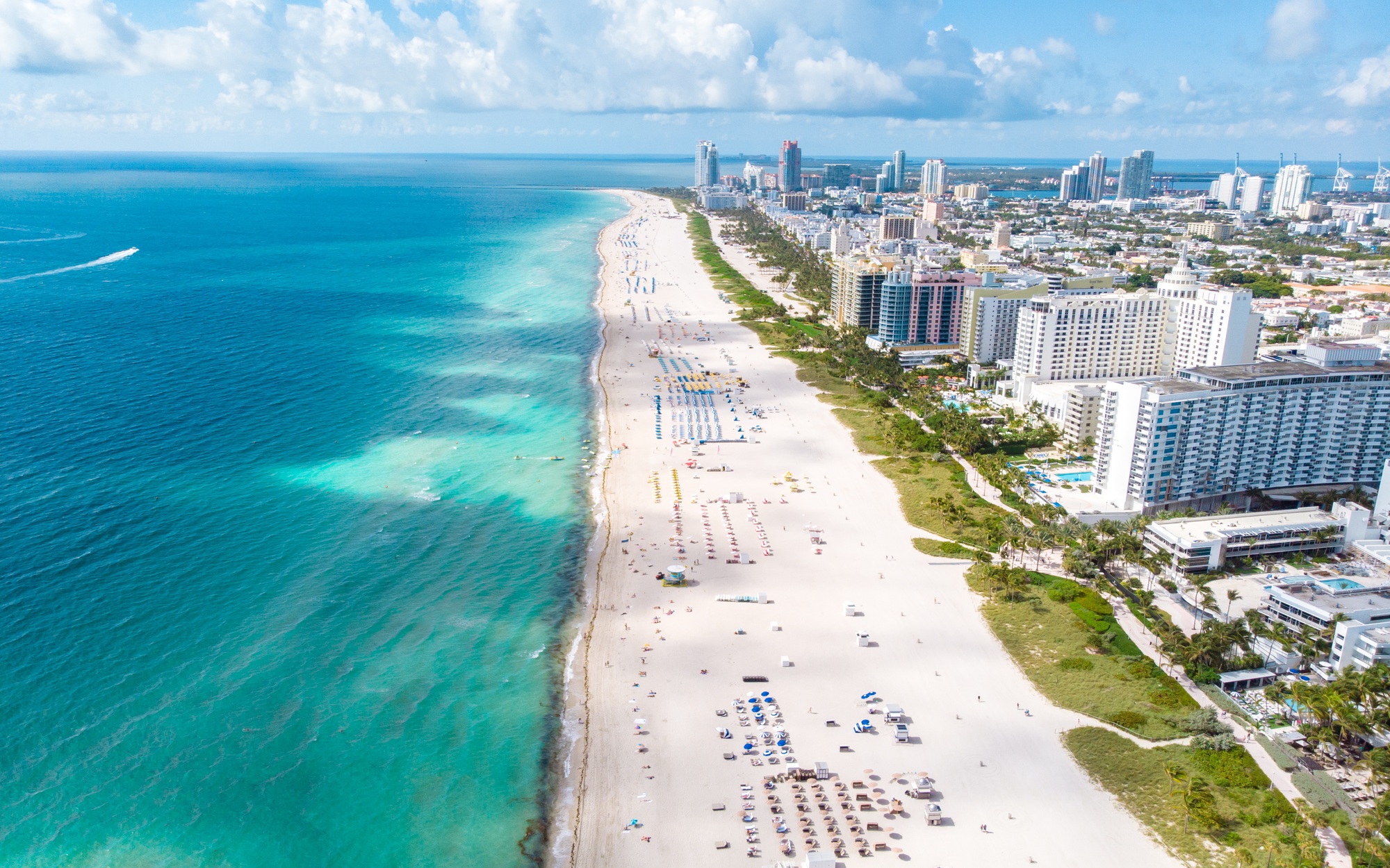 Drone aerial view at Miami South Beach Florida, Beach with colorful chairs and umbrellas